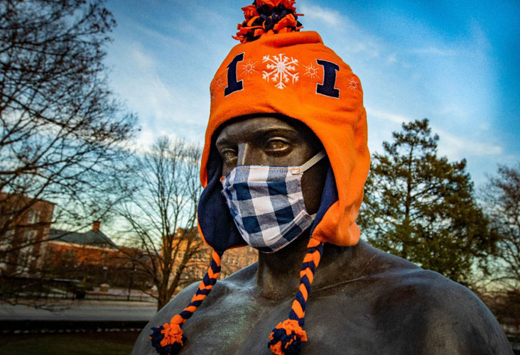 Alma Mater in winter hat and face mask