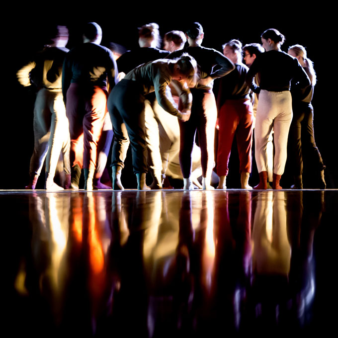 group of dancer huddled in a dance position