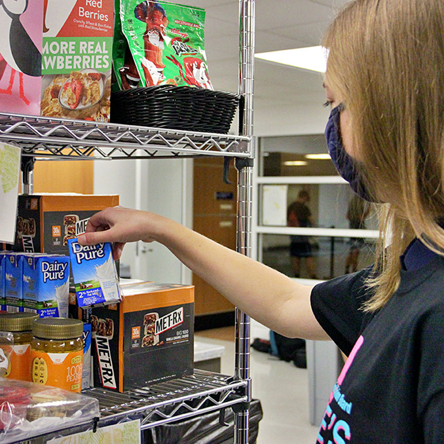 students looking at packaged goods on a shelf